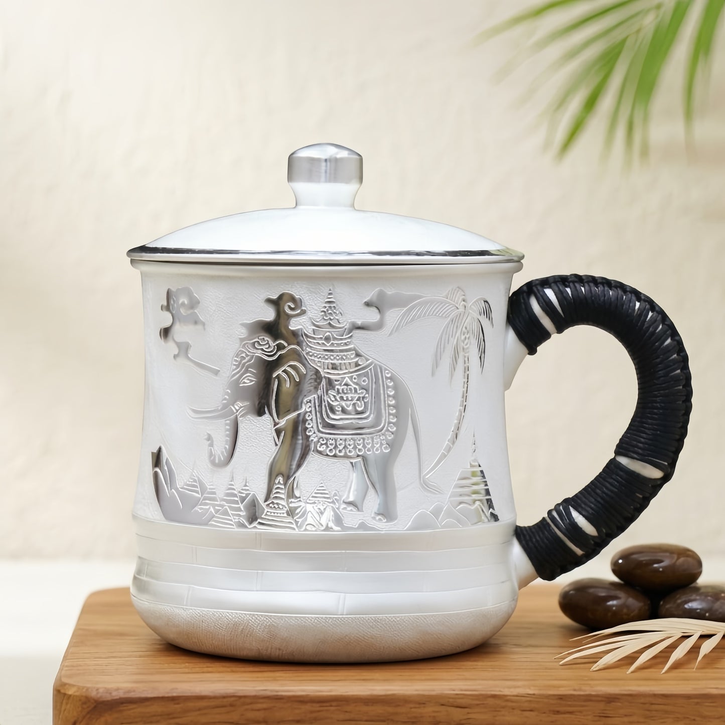 Braided black handle and silver-tone lid knob on the elephant temple porcelain mug