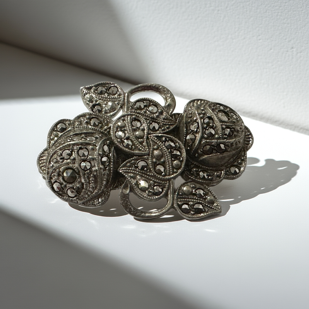 925 sterling silver marcasite brooch featuring intricate floral design and vintage charm, perfect for elegant occasions.